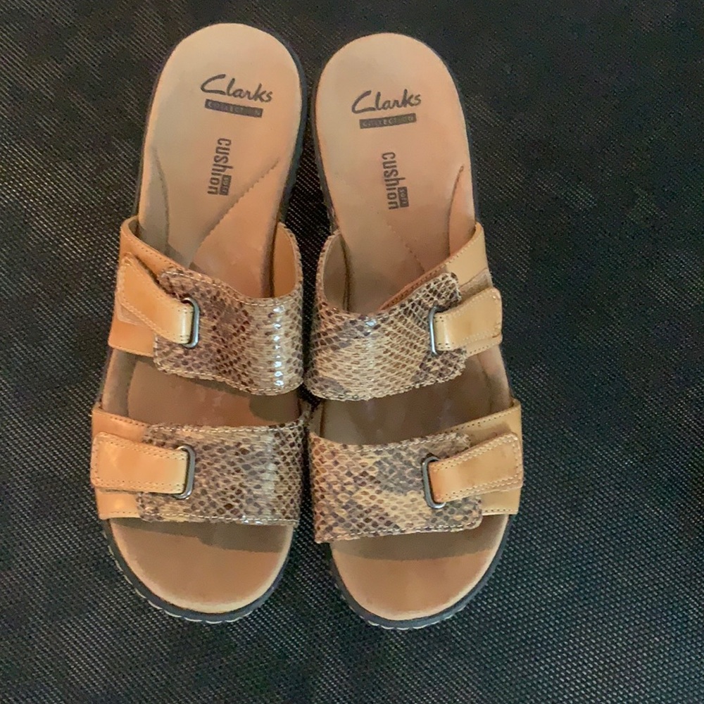 Tan wedge sandals with snakeskin pattern by Clarks